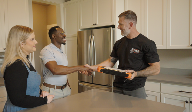 A Live Wire Electric team member meeting homeowners in their kitchen